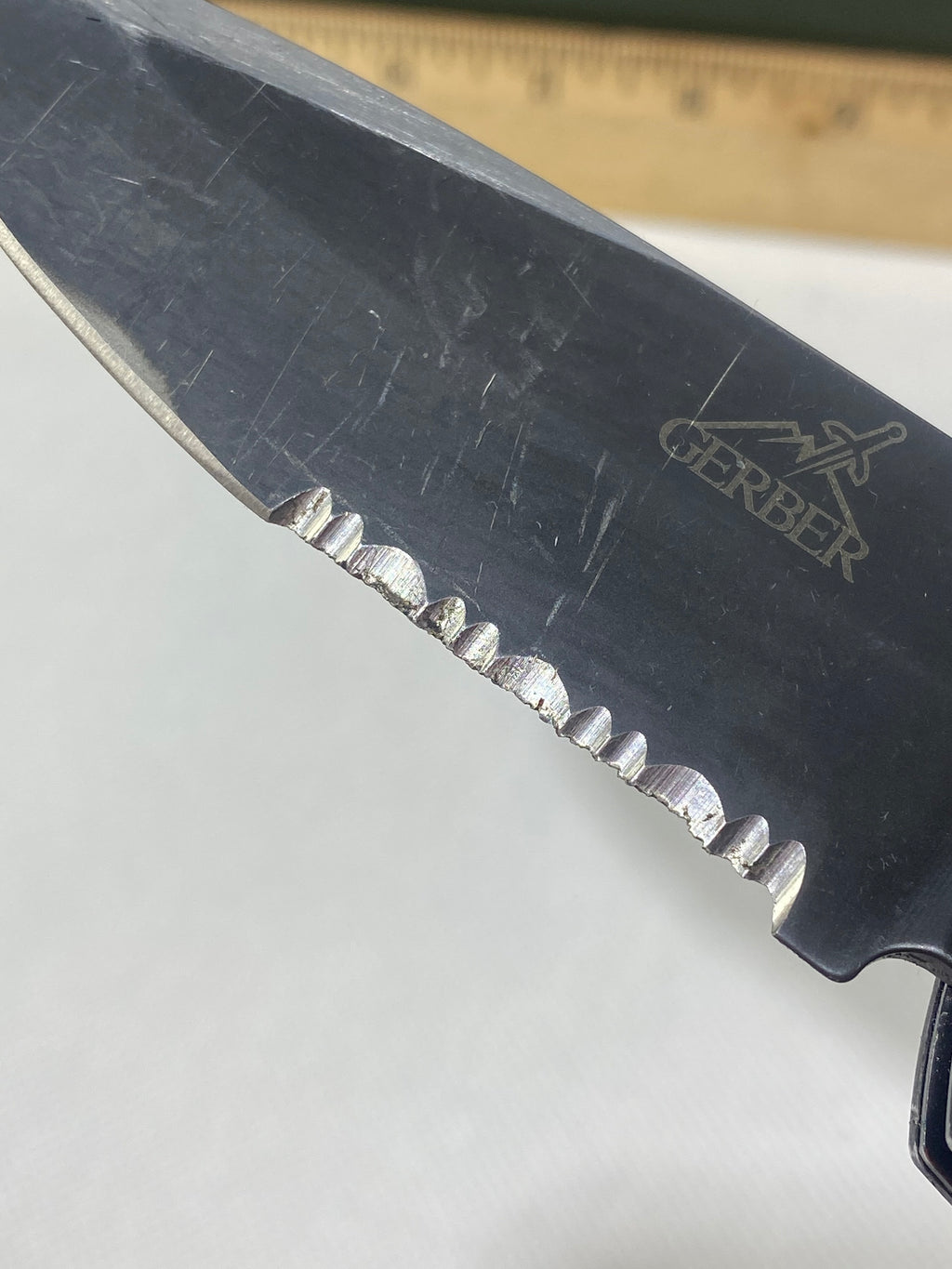 Gerber -85. 06. Light usage. Resharpened. A name is scratched into the blade. Needs Oil.