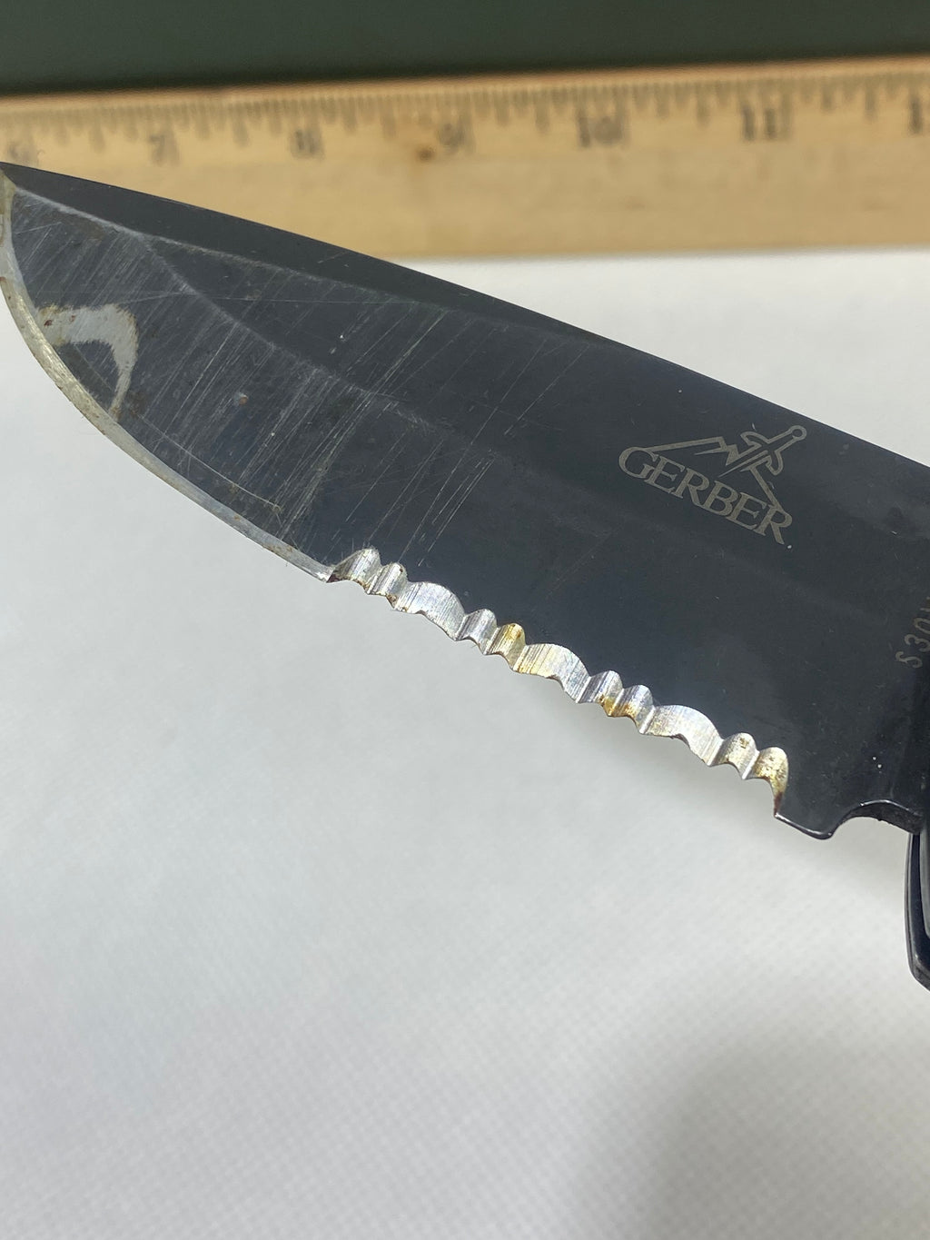 Gerber -89. 06. Light usage. Resharpened. Possible rust. Handle scratched. Dirty.