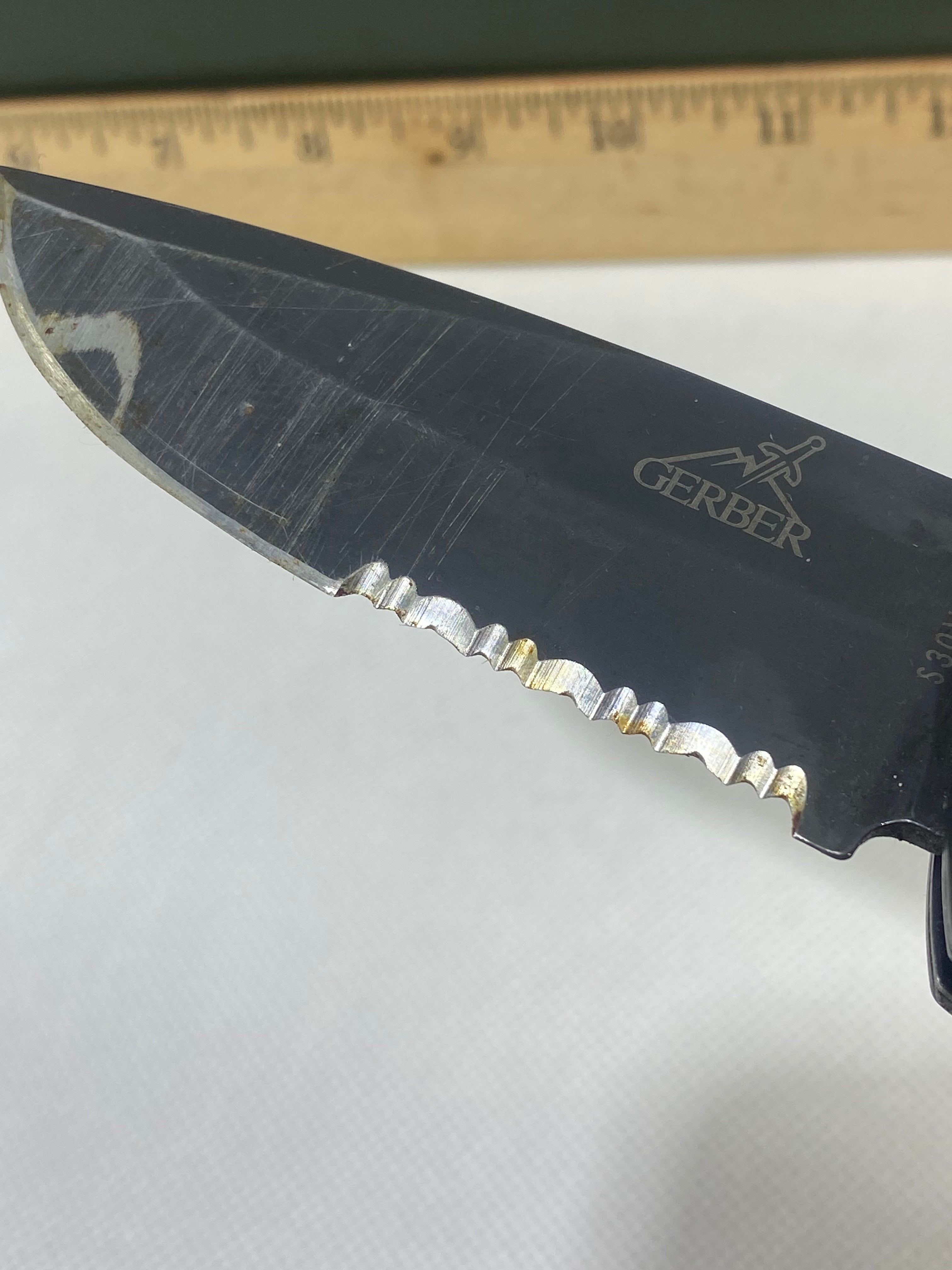 Gerber -89. 06. Light usage. Resharpened. Possible rust. Handle scratched. Dirty.